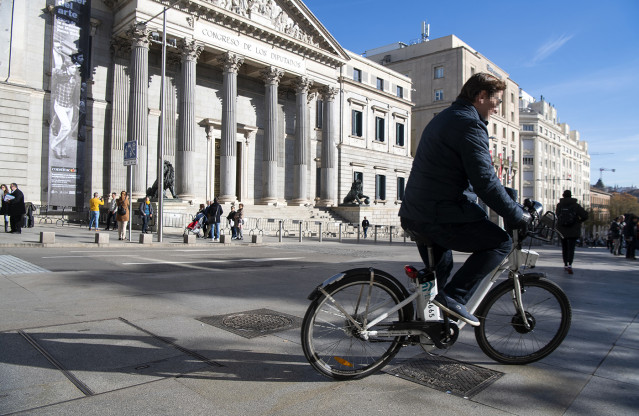 Muévete con un Plan. Primer plano de un ciclista circulando por delante del Congreso de los Diputados